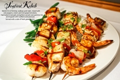 Seafood Kebob - Kebob trio of shrimp, scallops and mahi, mixed with red peppers, onions and red grape tomatoes, marinated in teriyaki and grilled, served over jasmine rice and topped with scallions and peanuts. Served with a side of fresh green beans
